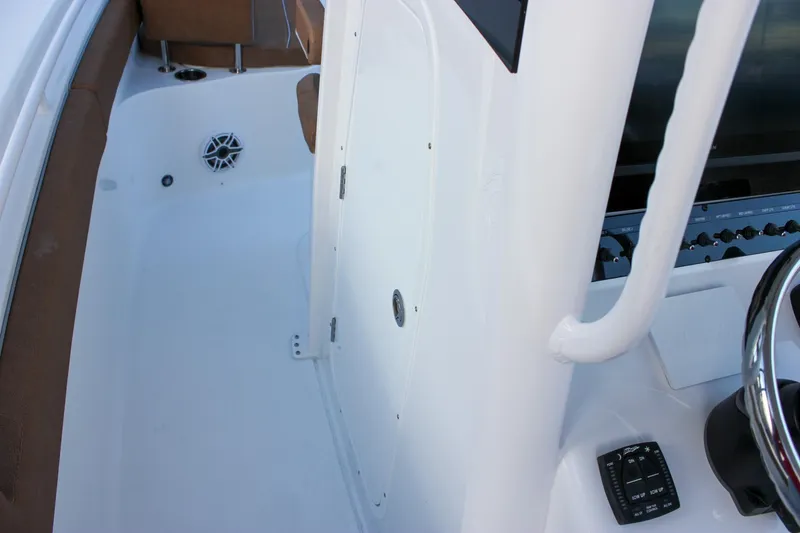 Slide: The Image of 2026 Sea Hunt Gamefish 28 Forward Seating boat interior with steering console and seating area. - 20