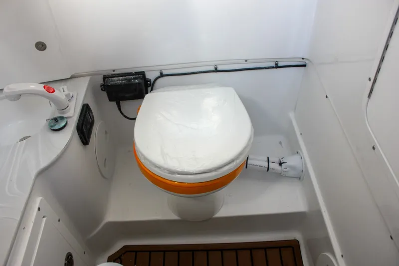 Slide: The Image of 2026 Sea Hunt Gamefish 28 boat bathroom with toilet and sink. - 23