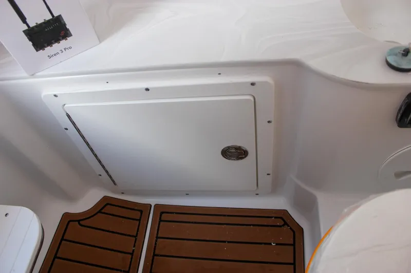 Slide: The Image of 2026 Sea Hunt Gamefish 28 Forward Seating boat interior with storage compartment and teak flooring. - 24
