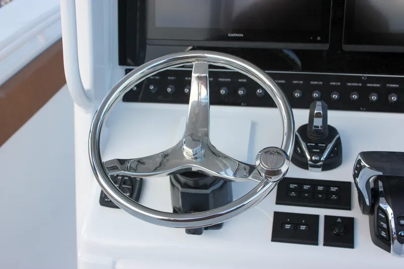 Slide: The Image of Steering wheel and controls of 2026 Sea Hunt Gamefish 28 Forward Seating boat. - 33