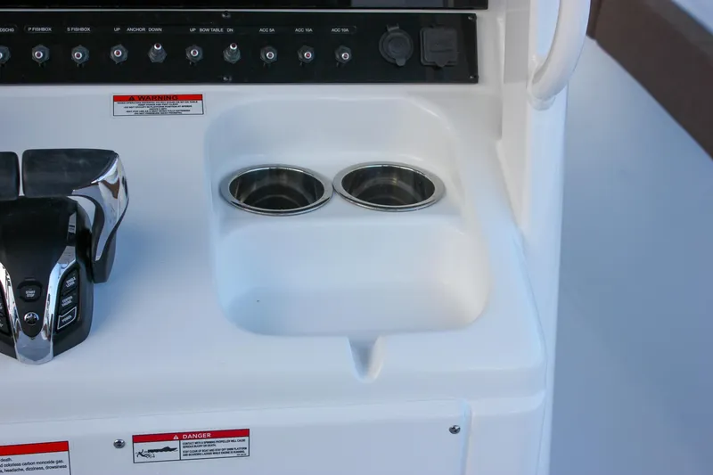 Slide: The Image of Control panel and cup holders on 2026 Sea Hunt Gamefish 28 Forward Seating boat. - 35