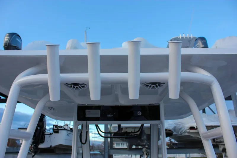 Slide: The Image of 2026 Sea Hunt Gamefish 28 boat with rod holders and T-top, viewed from below. - 37