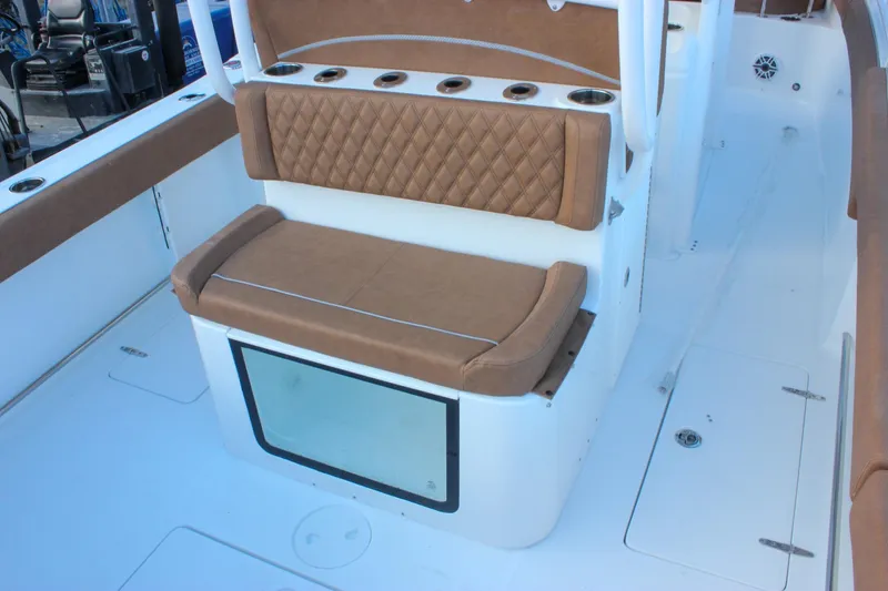Slide: The Image of 2026 Sea Hunt Gamefish 28 Forward Seating with tan cushioned bench and rod holders. - 4