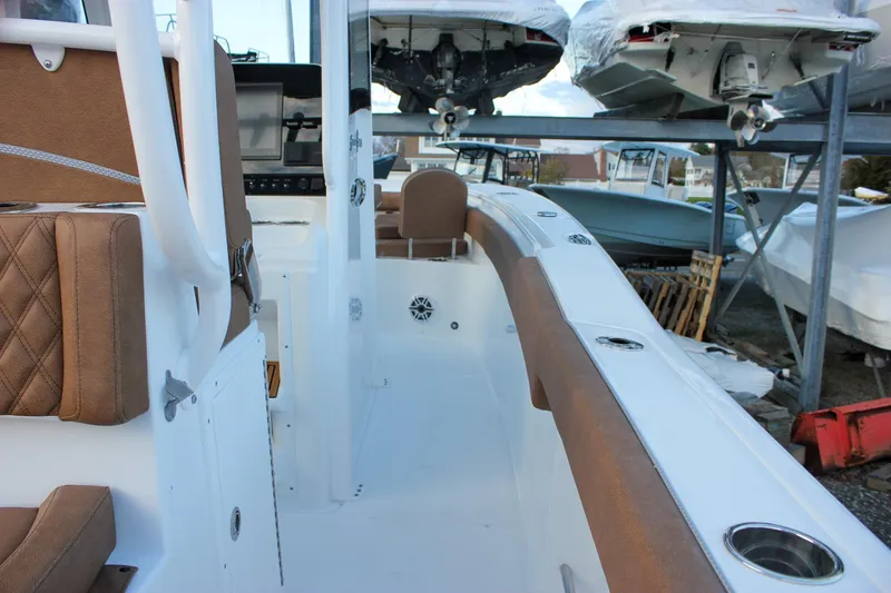 Slide: The Image of 2026 Sea Hunt Gamefish 28 Forward Seating boat interior with brown cushioned seats. - 41