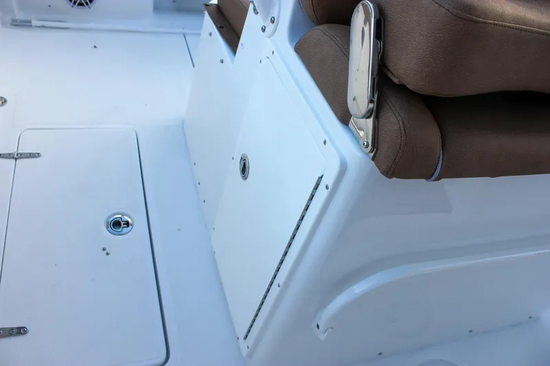 Slide: The Image of 2026 Sea Hunt Gamefish 28 Forward Seating interior with brown seating and storage compartments. - 42