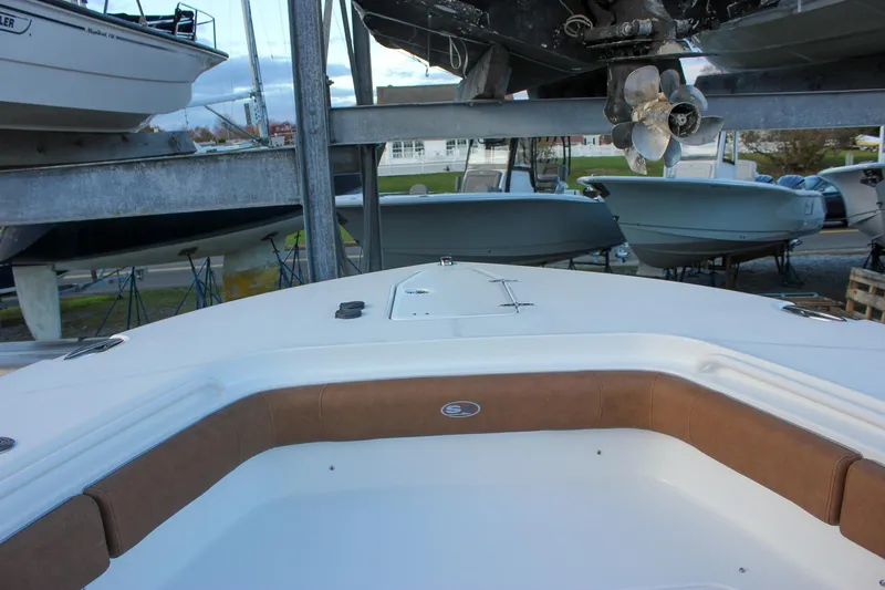 Slide: The Image of 2026 Sea Hunt Gamefish 28 Forward Seating boat in storage, showcasing bow area. - 55