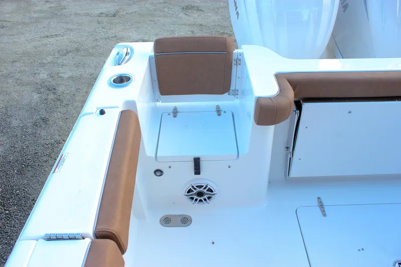 Slide: The Image of 2026 Sea Hunt Gamefish 28 Forward Seating boat interior with brown cushions and storage compartments. - 6