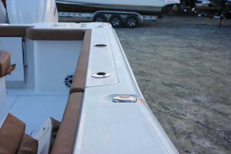 Slide: The Image of 2026 Sea Hunt Gamefish 28 Forward Seating boat interior with brown cushions and rod holders. - 62