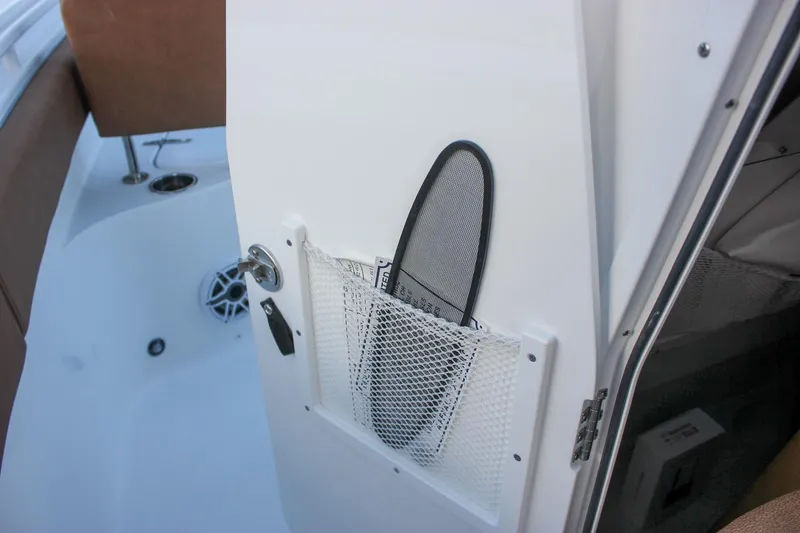 Slide: The Image of 2026 Sea Hunt Gamefish 28 interior with storage pocket and speaker detail. - 65