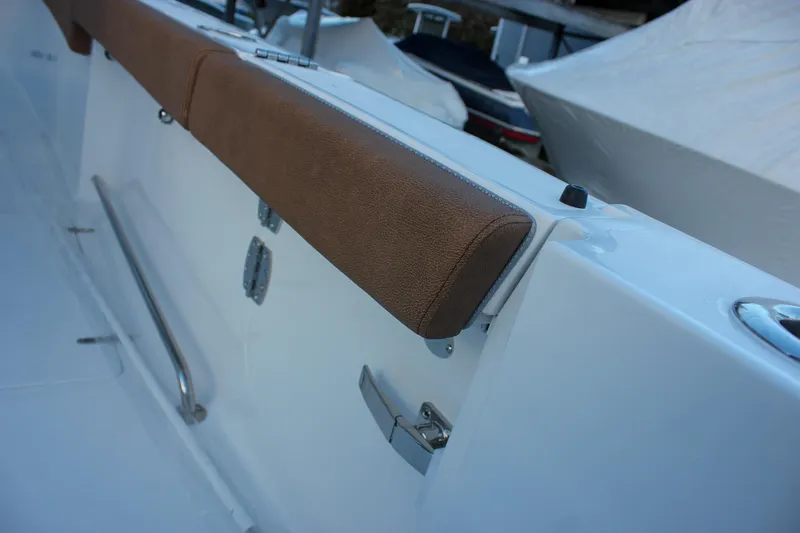 Slide: The Image of 2026 Sea Hunt Gamefish 28 Forward Seating boat interior with brown cushioned seating. - 68