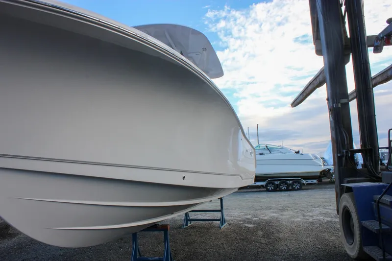 Slide: The Image of 2026 Sea Hunt Gamefish 28 Forward Seating boat on display in a marina setting. - 74