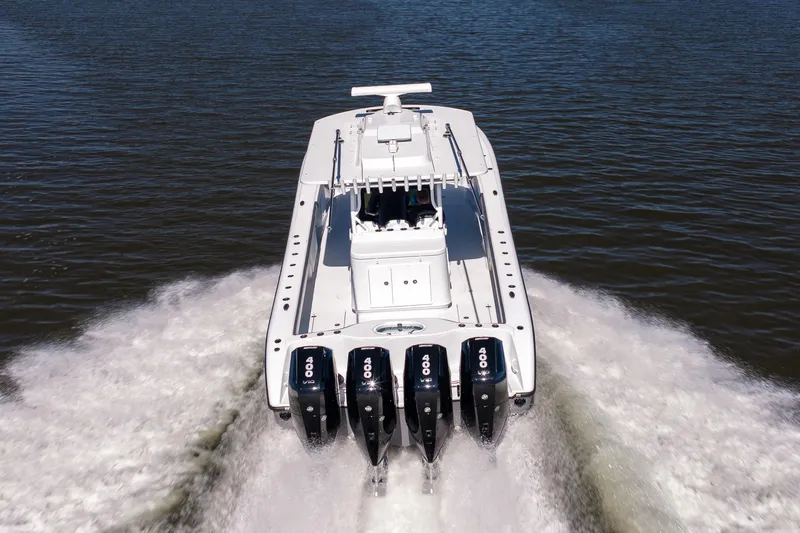 Slide: The Image of 2024 Yellowfin 39 Offshore boat with four powerful engines cruising on water. - 12