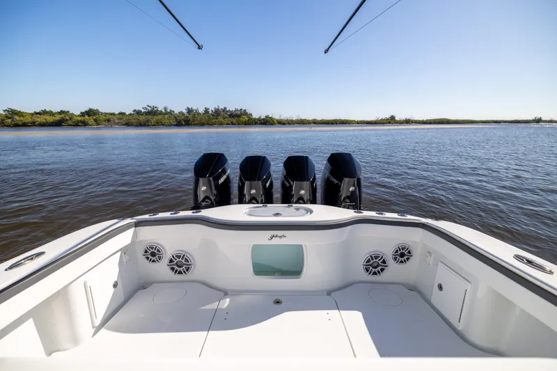 Slide: The Image of 2024 Yellowfin 39 Offshore boat with four powerful engines on calm water. - 18
