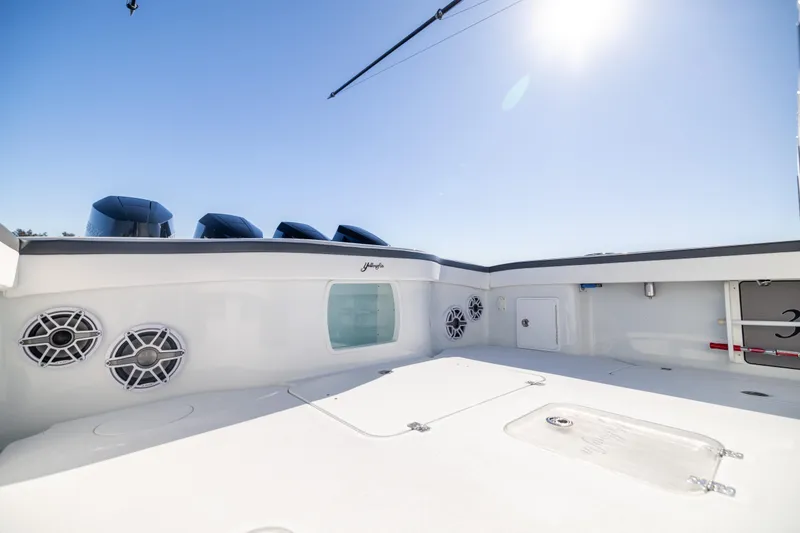 Slide: The Image of 2024 Yellowfin 39 Offshore boat deck with speakers and clear sky. - 22