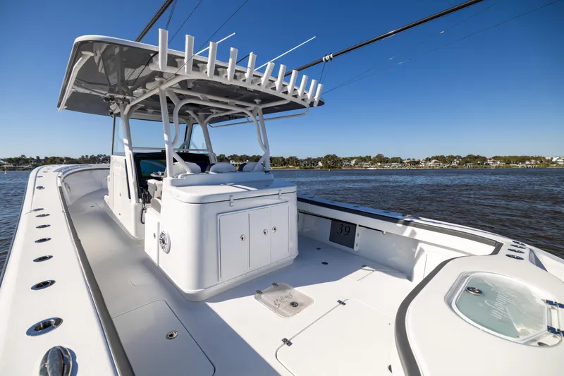 Slide: The Image of 2024 Yellowfin 39 Offshore boat on water, showcasing spacious deck and sleek design. - 26