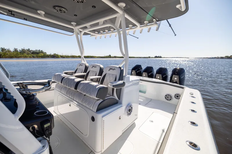 Slide: The Image of 2024 Yellowfin 39 Offshore boat interior with seating and multiple outboard engines on a sunny day. - 29