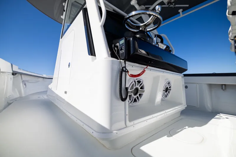 Slide: The Image of 2024 Yellowfin 39 Offshore boat console with steering wheel and speakers. - 38