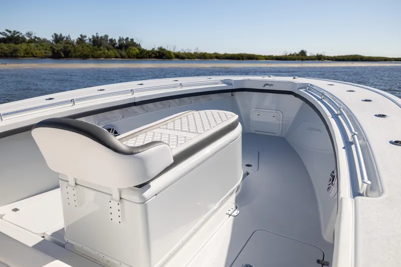 Slide: The Image of 2024 Yellowfin 39 Offshore boat interior with seating, on a sunny day by the water. - 45