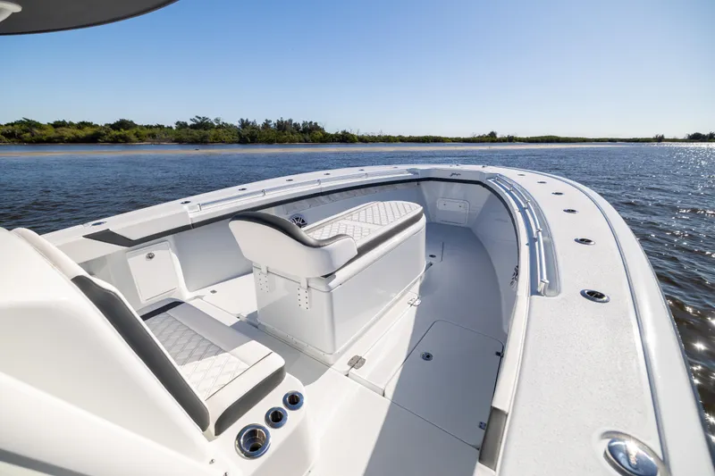 Slide: The Image of 2024 Yellowfin 39 Offshore boat interior, featuring sleek seating and spacious deck on calm waters. - 46