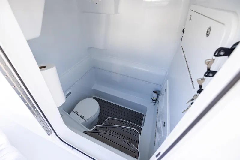 Slide: The Image of 2024 Yellowfin 39 Offshore boat interior with toilet and storage area. - 54