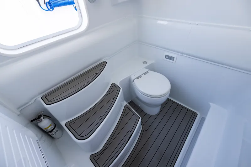 Slide: The Image of 2024 Yellowfin 39 Offshore boat bathroom with toilet and non-slip flooring. - 55