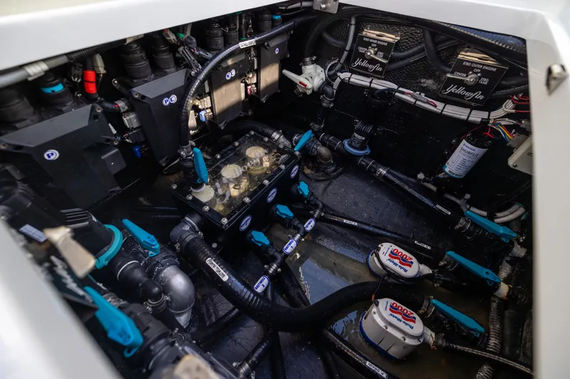 Slide: The Image of Engine compartment of 2024 Yellowfin 39 Offshore boat, showcasing intricate wiring and components. - 58