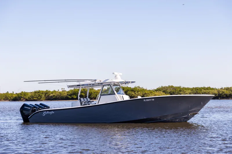 Slide: The Image of 2024 Yellowfin 39 Offshore boat on calm water, side view. - 8