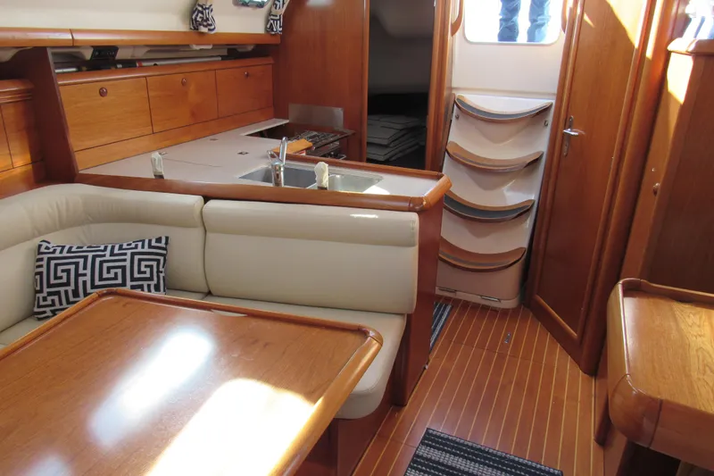 Slide: The Image of Interior of 2004 Jeanneau Sun Odyssey 37 yacht with wooden cabinetry and seating. - 10