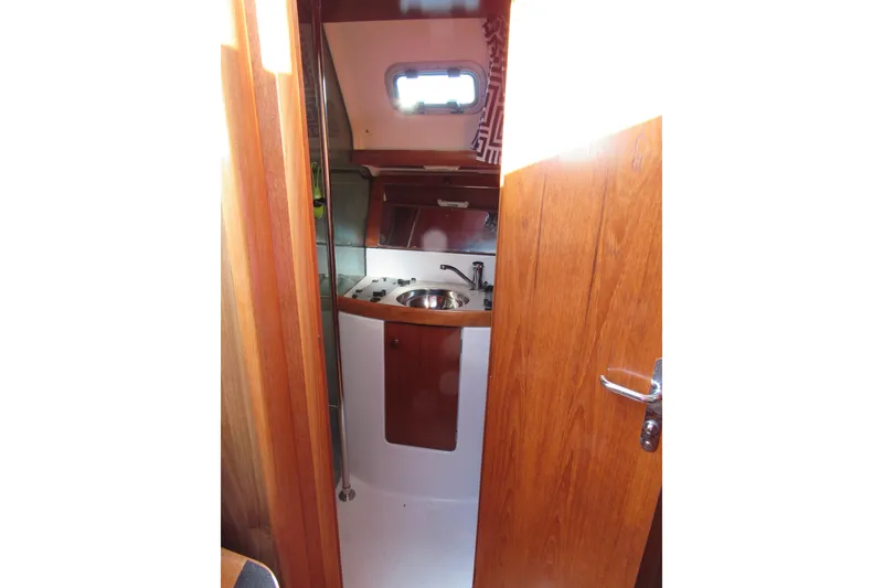 Slide: The Image of Interior view of 2004 Jeanneau Sun Odyssey 37 sailboat kitchen area. - 13