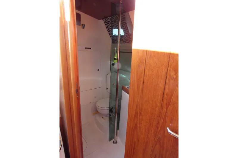 Slide: The Image of Interior view of 2004 Jeanneau Sun Odyssey 37 yacht bathroom with wooden door and modern fixtures. - 17