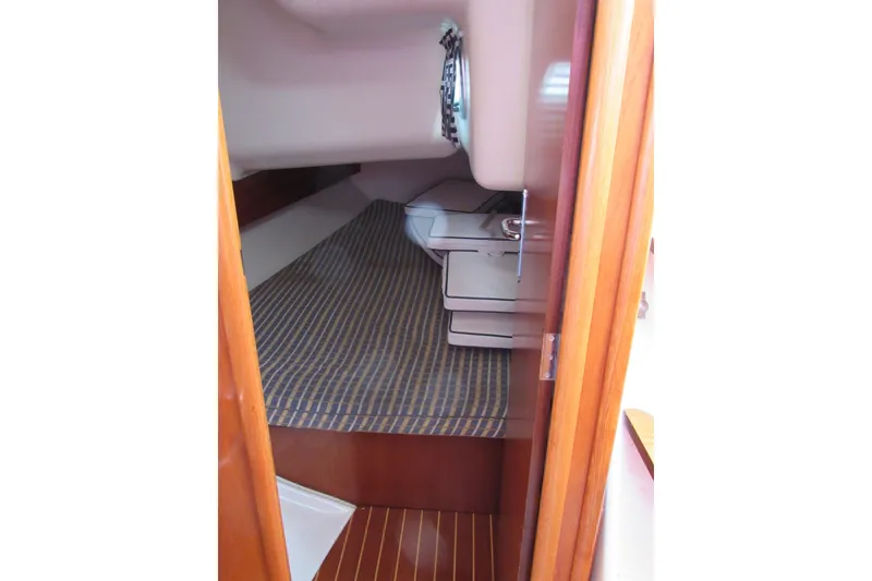 Slide: The Image of Cabin interior of 2004 Jeanneau Sun Odyssey 37 sailboat with striped bedding. - 19