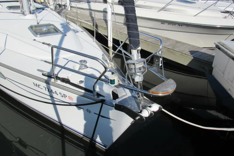 Slide: The Image of 2004 Jeanneau Sun Odyssey 37 sailboat docked, showing bow and anchor details. - 2