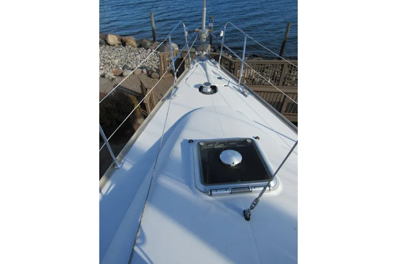 Slide: The Image of Deck view of 2004 Jeanneau Sun Odyssey 37 sailboat by the water. - 28