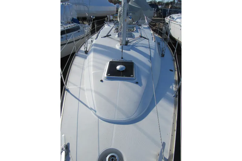 Slide: The Image of 2004 Jeanneau Sun Odyssey 37 sailboat deck, showcasing sleek design and rigging. - 29