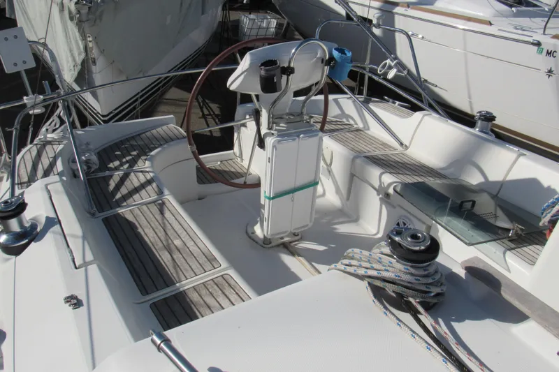 Slide: The Image of 2004 Jeanneau Sun Odyssey 37 sailboat cockpit with steering wheel and seating area. - 32