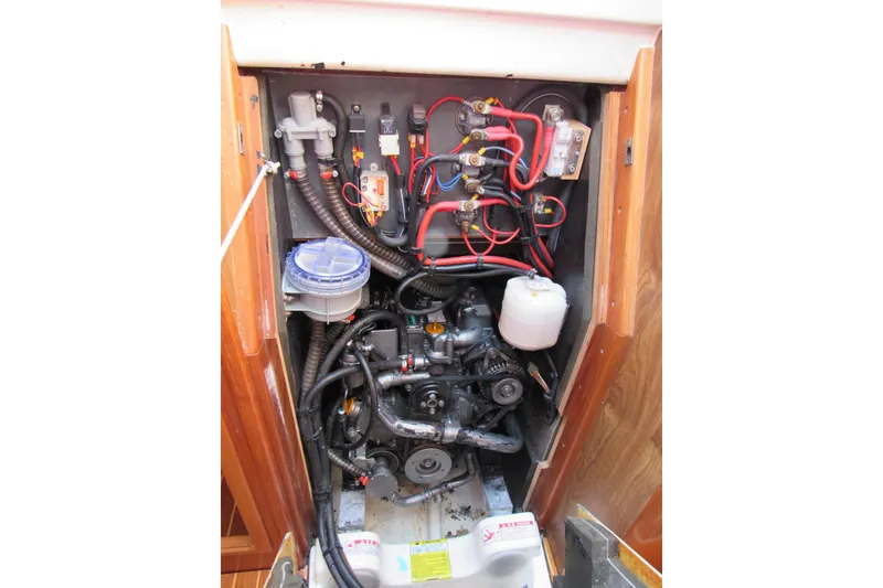 Slide: The Image of Engine compartment of 2004 Jeanneau Sun Odyssey 37 sailboat, showcasing wiring and components. - 34