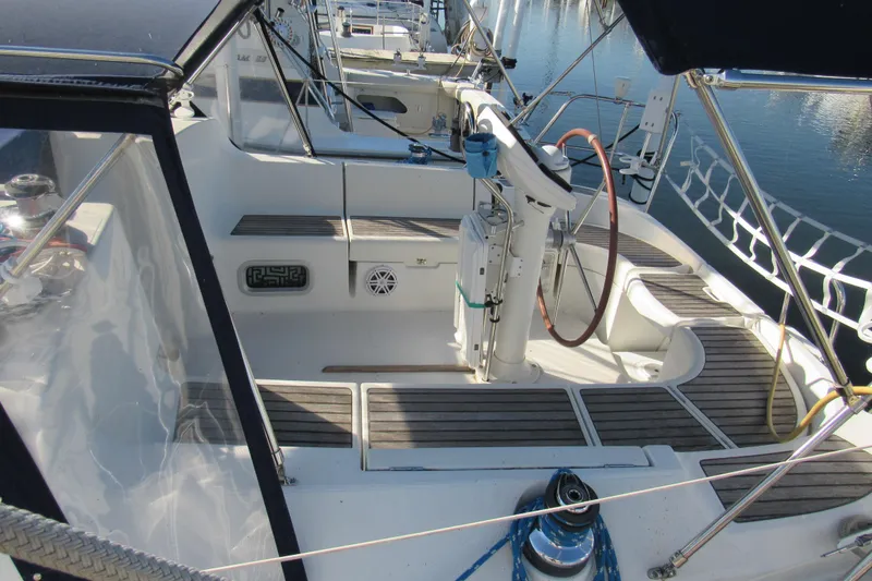 Slide: The Image of 2004 Jeanneau Sun Odyssey 37 sailboat cockpit with wooden deck and steering wheel. - 4