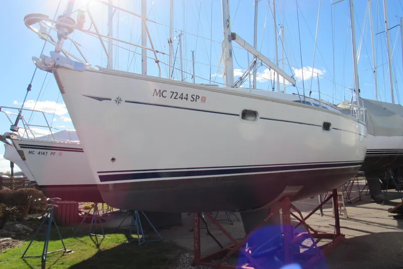 Slide: The Image of 2004 Jeanneau Sun Odyssey 37 sailboat on stands, sunny day, marina background. - 5