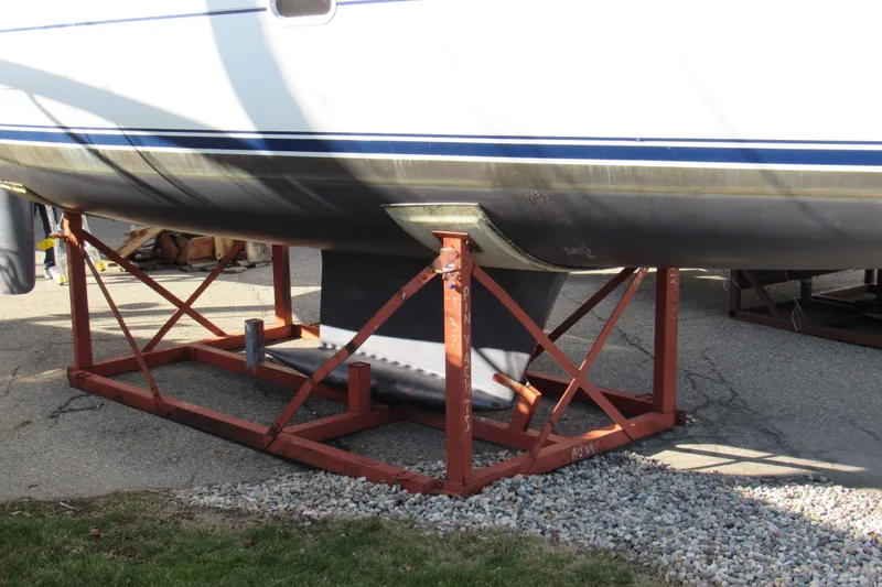 Slide: The Image of 2004 Jeanneau Sun Odyssey 37 sailboat on a metal stand, hull visible. - 7