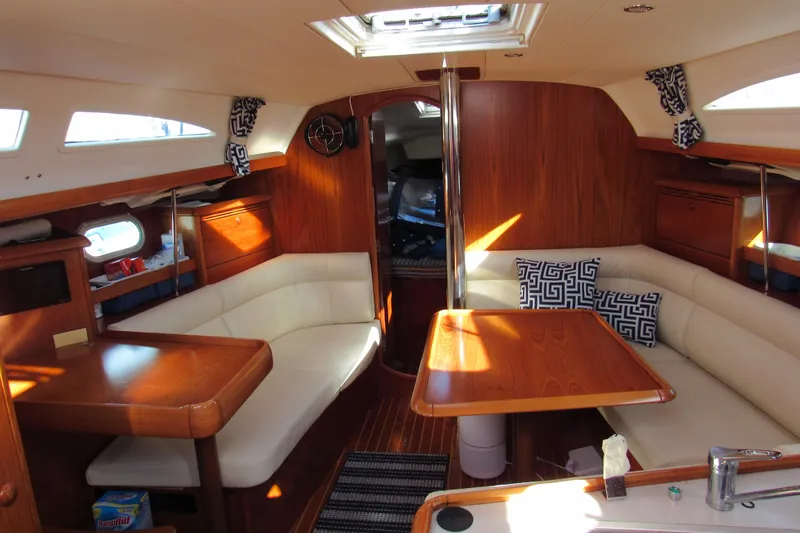 Slide: The Image of Interior of 2004 Jeanneau Sun Odyssey 37 sailboat with wood finish and white seating. - 8
