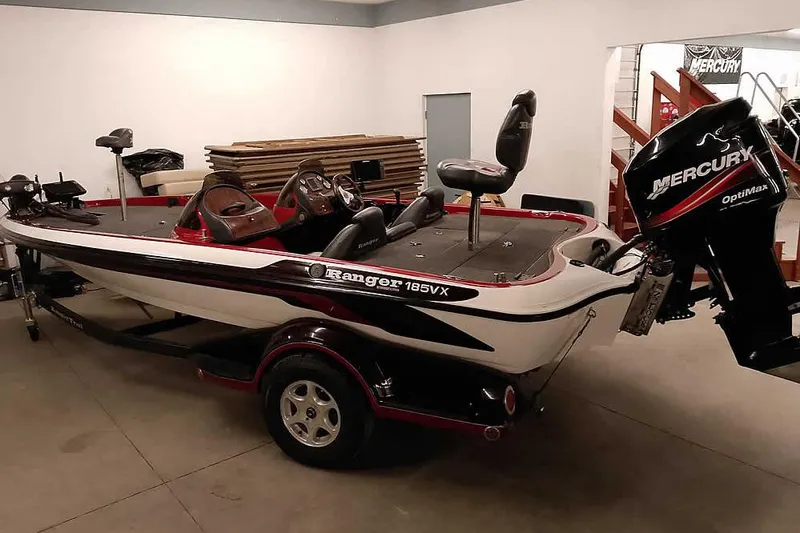 The Image of 2005 Ranger 185 VX boat with Mercury OptiMax engine in a garage setting. - 0