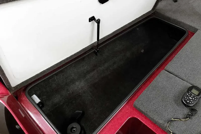 Slide: The Image of Open storage compartment in a 2005 Ranger 185 VX boat, with a device nearby. - 22