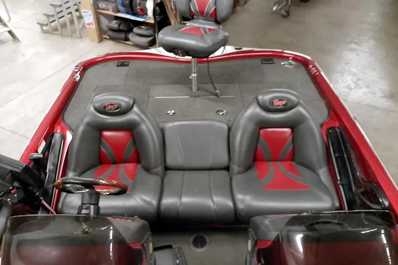 Slide: The Image of 2005 Ranger 185 VX boat interior with red and gray seating, steering wheel, and deck. - 25