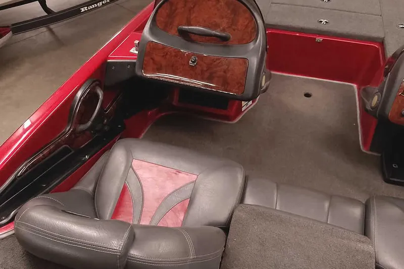 Slide: The Image of 2005 Ranger 185 VX boat interior with red and gray seating and wood accents. - 28