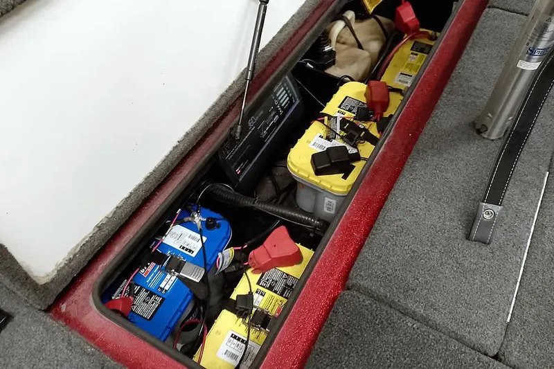 Slide: The Image of 2005 Ranger 185 VX boat battery compartment with multiple batteries and wiring. - 38
