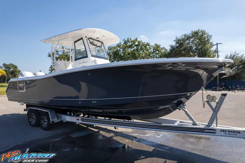 The Image of 2026 Sea Hunt Gamefish 28 Coffin Box boat on trailer, parked outdoors. - 1