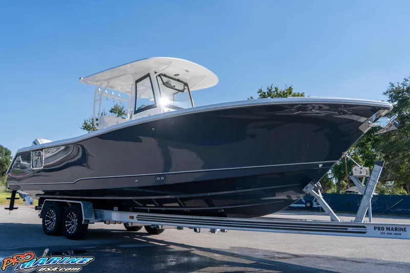 Slide: The Image of 2026 Sea Hunt Gamefish 28 Coffin Box boat on trailer, sunny day. - 13