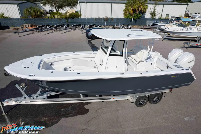 Slide: The Image of 2026 Sea Hunt Gamefish 28 Coffin Box boat on trailer, parked outdoors. - 14