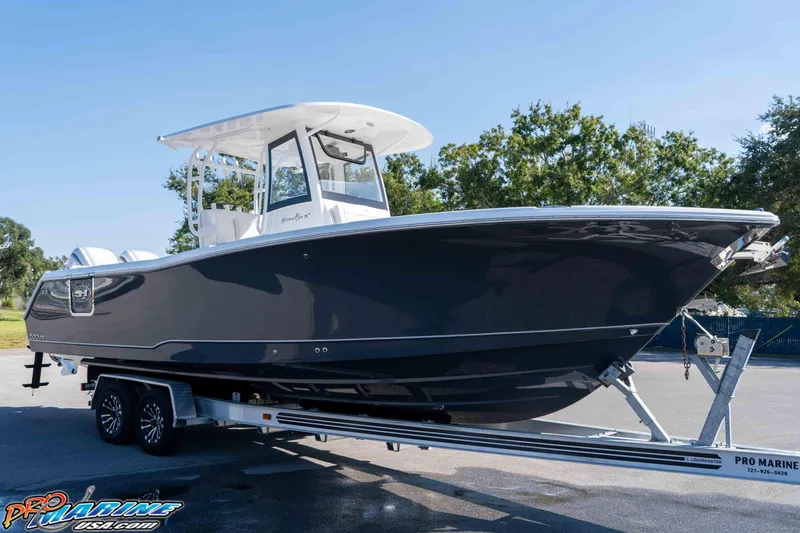 Slide: The Image of 2026 Sea Hunt Gamefish 28 Coffin Box boat on trailer, sleek design, outdoor setting. - 15
