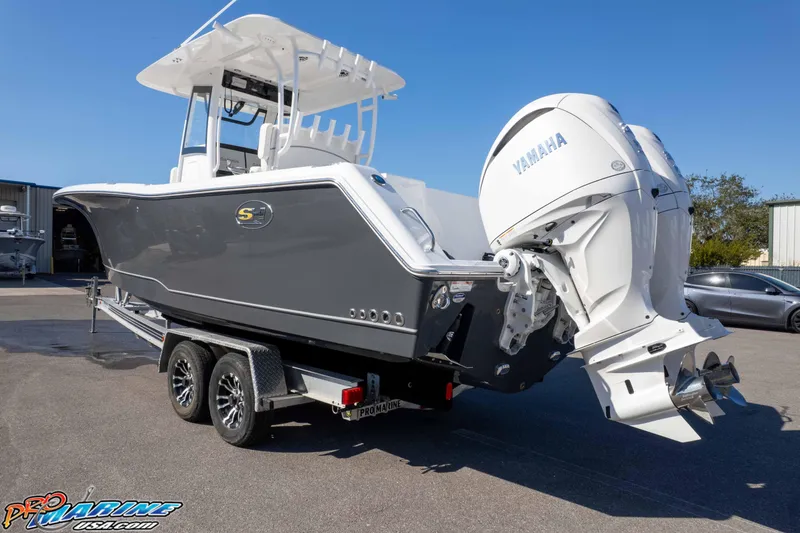 Slide: The Image of 2026 Sea Hunt Gamefish 28 Coffin Box boat with Yamaha engines on a trailer. - 16